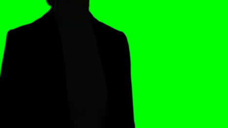 Woman-making-hand-gesture-against-green-screen-background