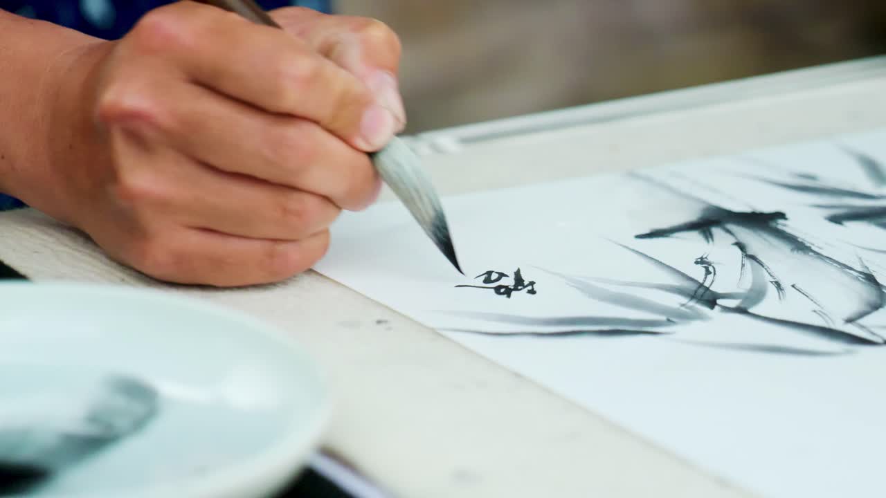 Slow Motion Footage of a Japanese Man Painting a Nihonga, a Traditional Japanese Painting, with Brushes and Black Ink
