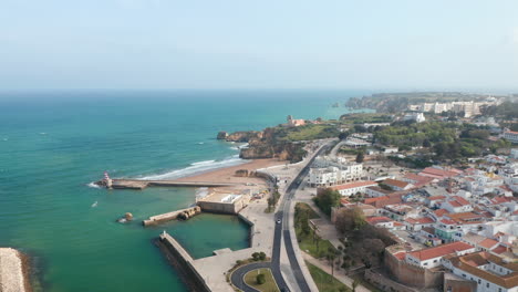 Amazing-aerial-drone-view-of-Lagos-sea-coastline,-drone-flying-above-city-with-background-ocean-horizon,-day