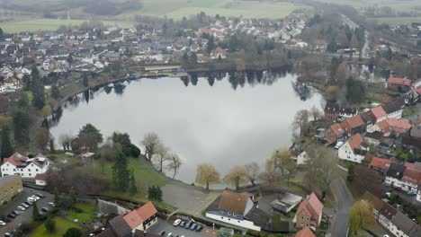 drone aerial view of the traditional german village herzberg am harz in the famous national park in central germany on a cloudy day in winter.