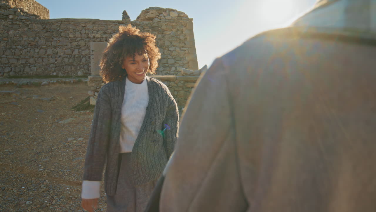 Carefree model posing photographer at evening beach closeup. Couple filming love