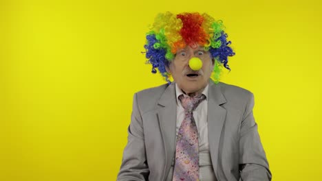 senior clown businessman freelancer show light bulb. came up with great idea