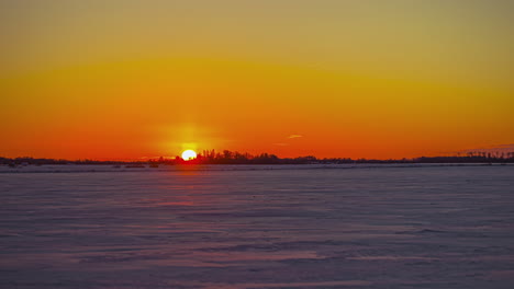 Time-lapseOF-golden-sunrise-over-the-water-and-an-island-on-the-horizon