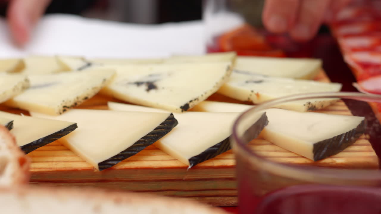 Slices Of Spanish Manchego Cheese On A Cheese Board. closeup