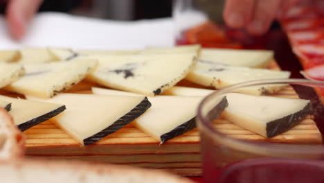 slices of spanish manchego cheese on a cheese board. closeup
