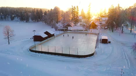 light snowfall over frozen lake while four people