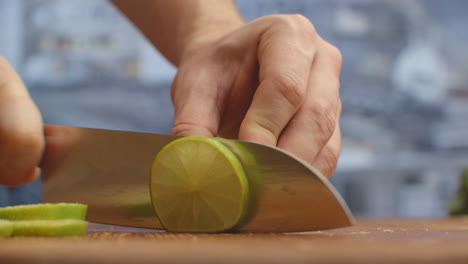 cut with a knife on a wooden board closeup green lime in the kitchen. shred