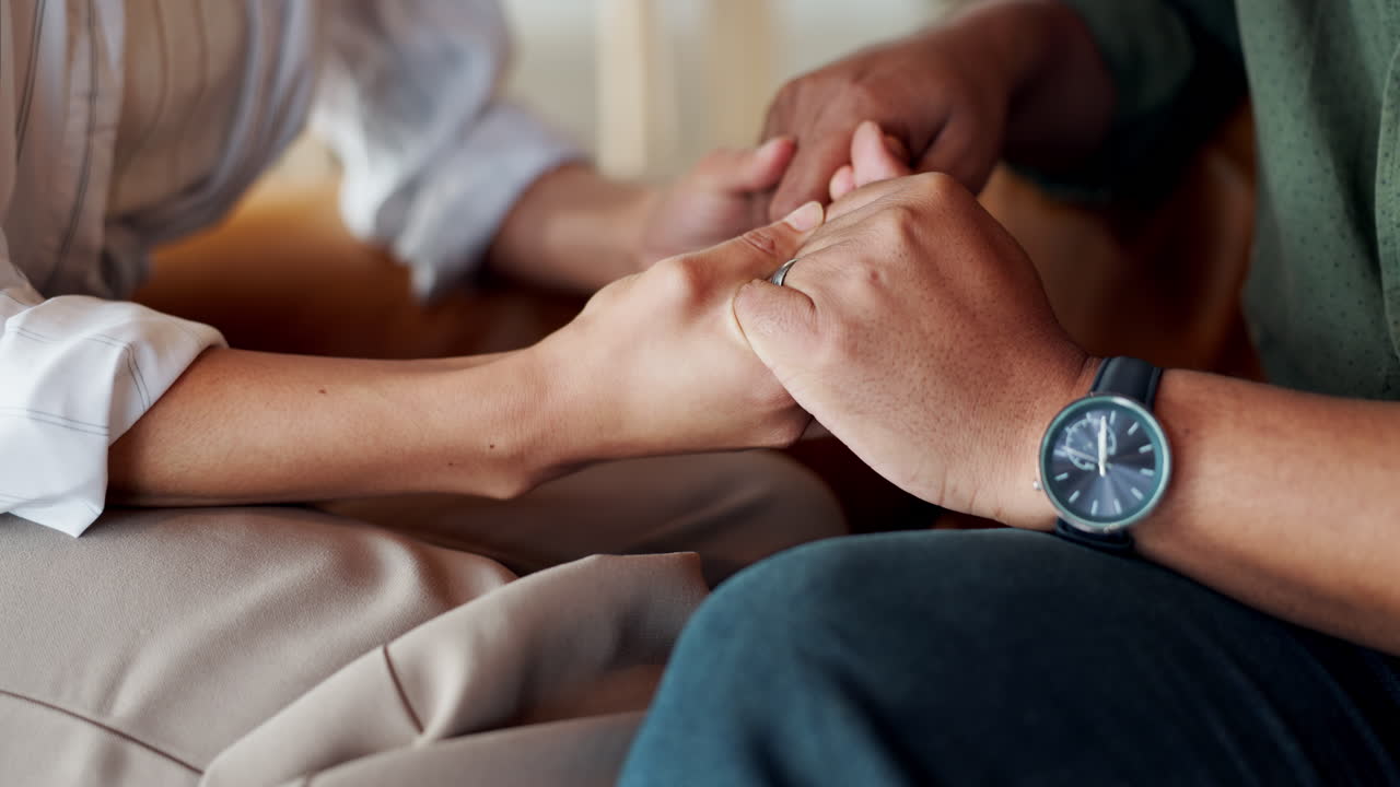 A couple holding hands in a supportive and loving relationship
