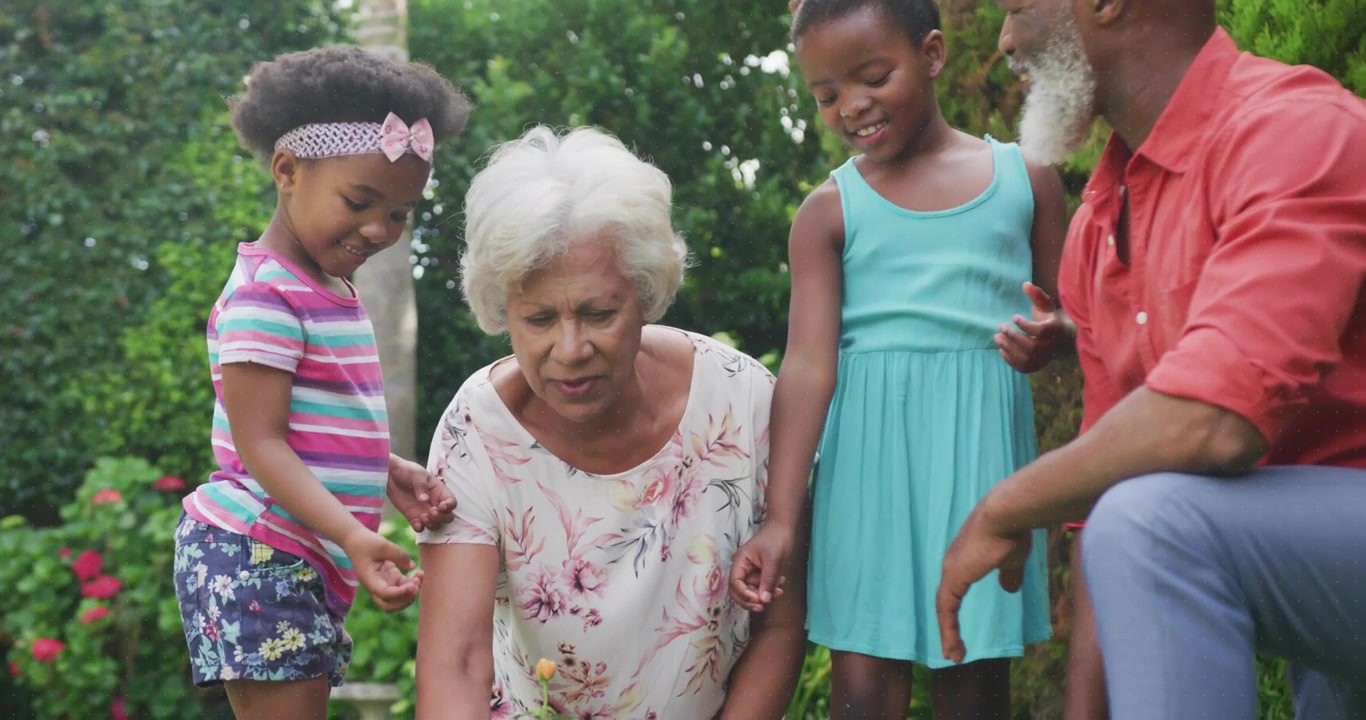 Animated rings spinning over blurred garden educating grandchildren in gardening with watering can