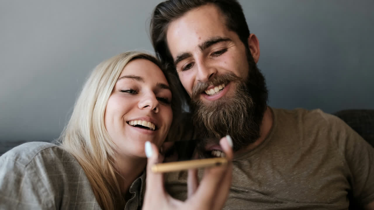 Couple talking on mobile phone in living room 4k