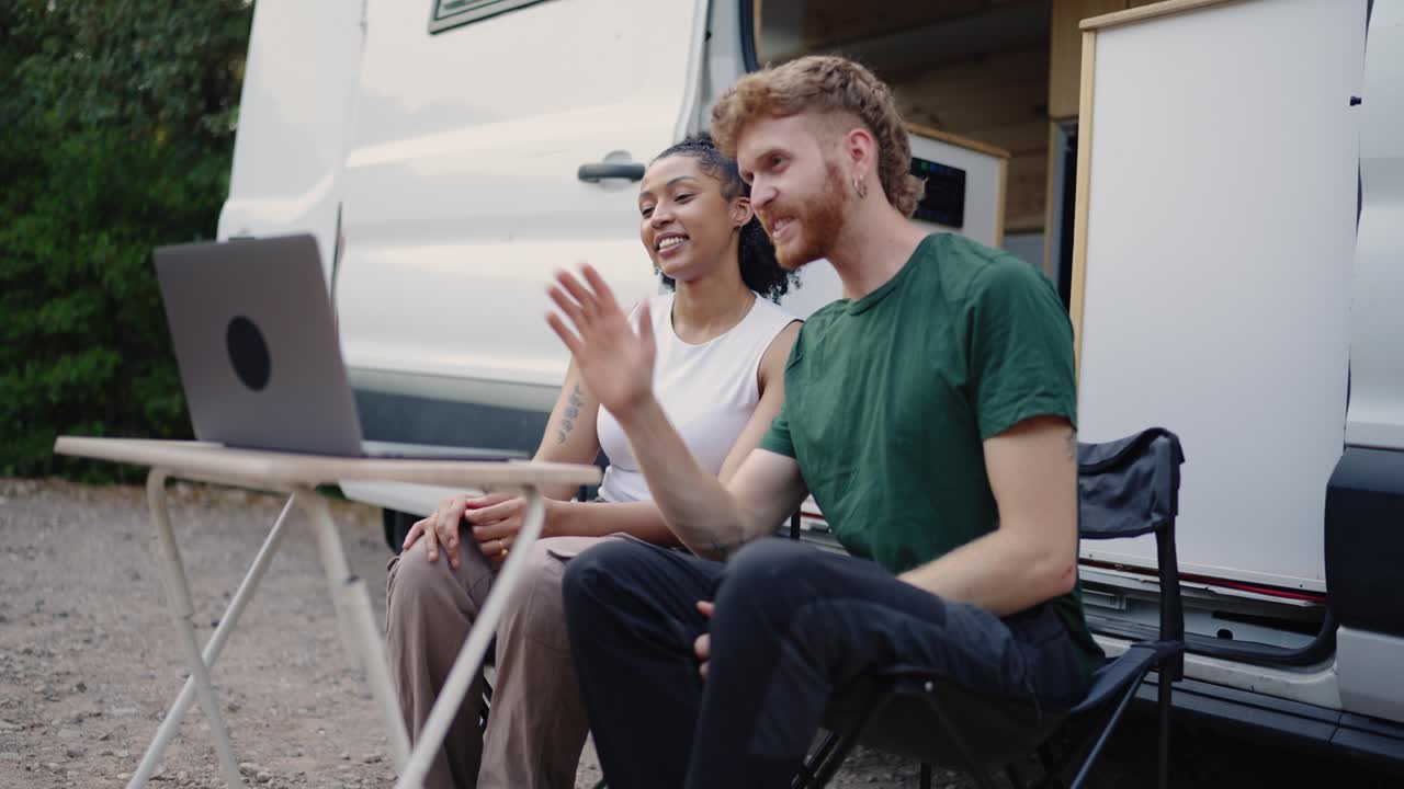 Couple making a video call from their camper van