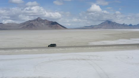 freedom concept - car on open road drive in salt flats desert, utah