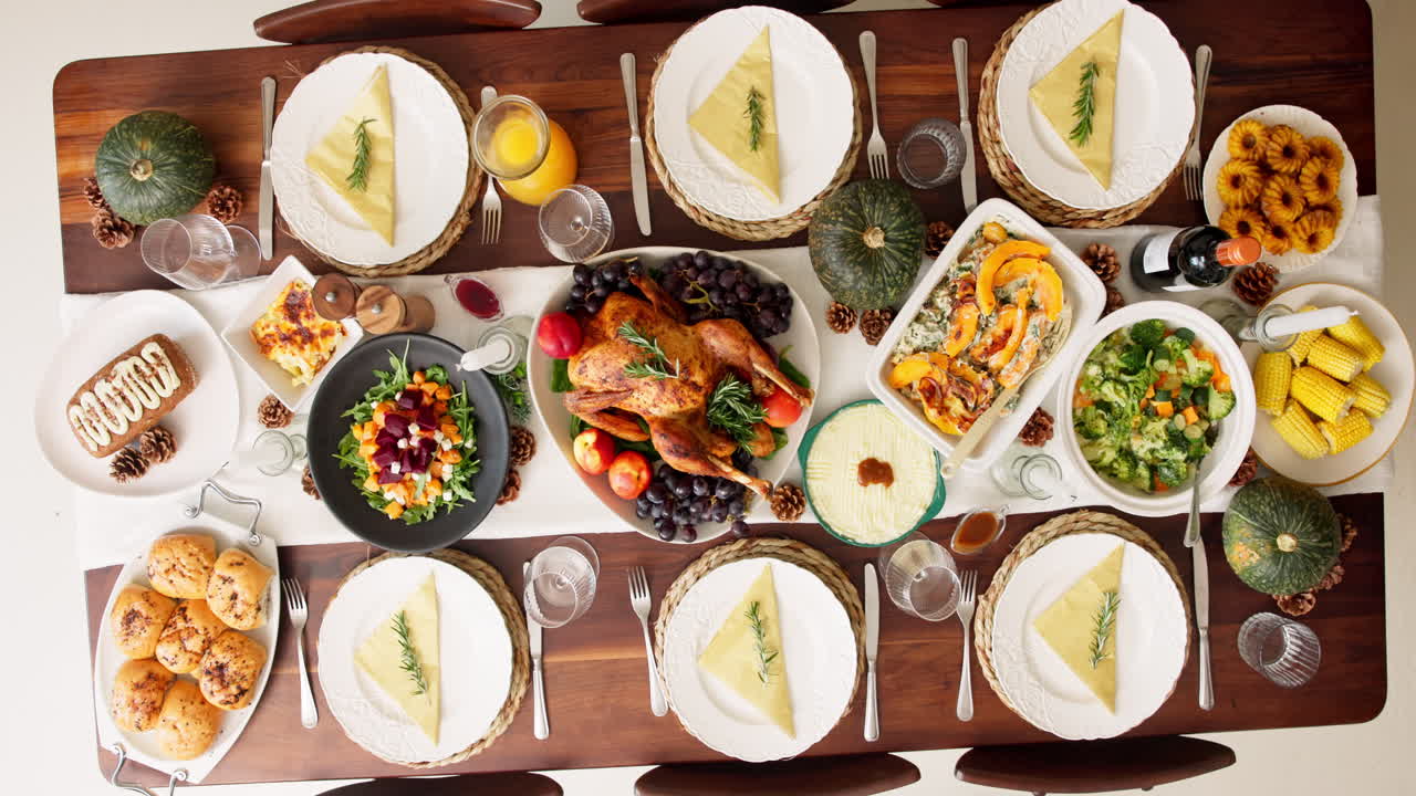 Thanksgiving dinner table setting with turkey and autumnal dishes