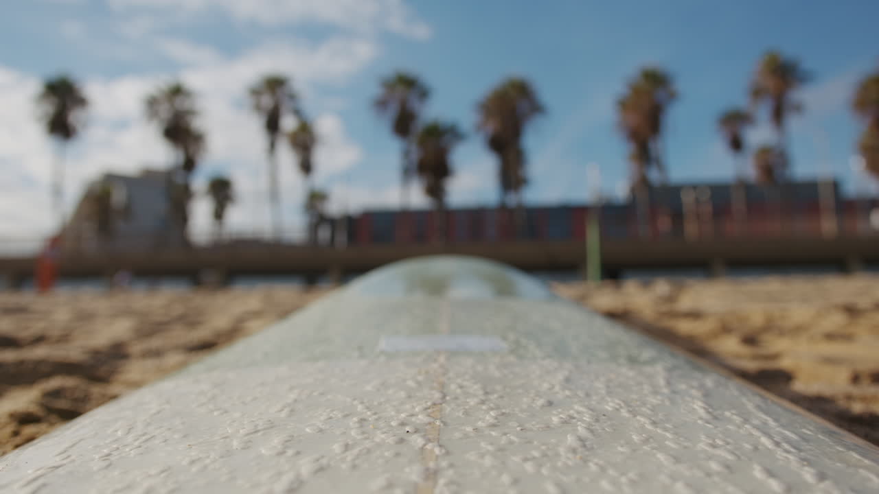 Surfer man walking to the beach at sunset preparing for surfing training and search for waves in Barcelona, spain, water, ocean exercise in sea with board, athletic male holiday or travel in vacation