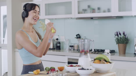 beautiful young woman making a smoothie