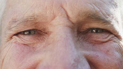 Portrait-of-close-up-of-eyes-of-happy-unaltered-senior-caucasian-man,-in-slow-motion