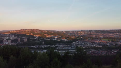 Golden-Hour-Lighting-Over-Hilltop-City-Houses-at-Sunrise---Aerial-Footage