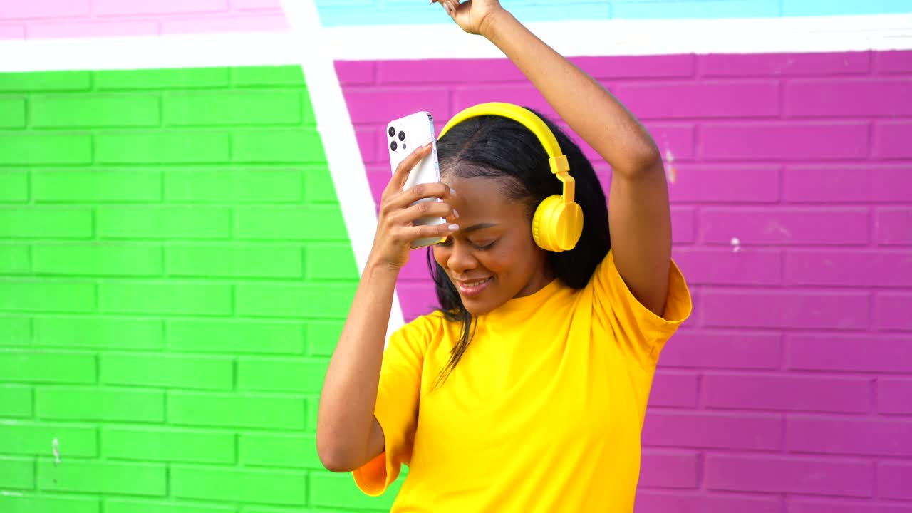 Woman dancing and listening to music with headphones