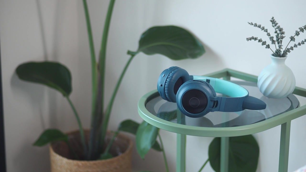Blue and Teal Headphones Resting on a Modern Side Table