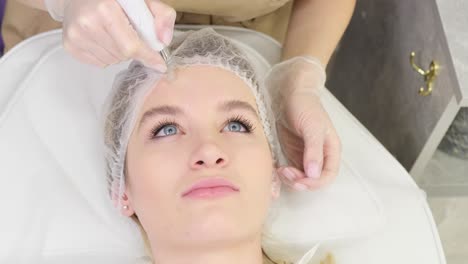 woman receiving microneedling treatment