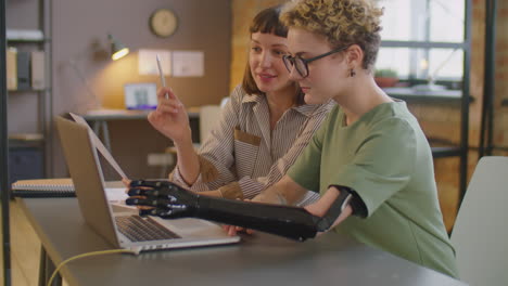 Businesswoman Talking with Colleague with Prosthetic Arm in Office