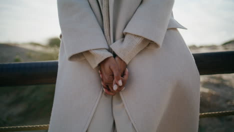 nervous woman hands rubbing outdoors closeup. stressed girl comforting herself