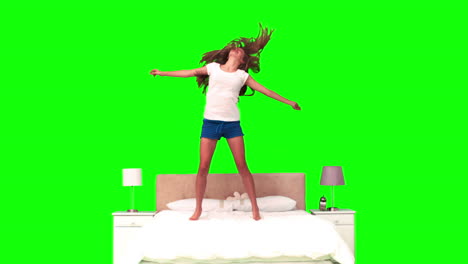 woman jumping on her bed in slow motion