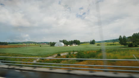 drive along the road along rural land in norway