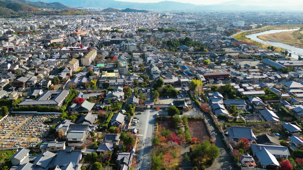 Aerial view flying over the cityscape of Arashiyama, fall day in Kyoto, Japan