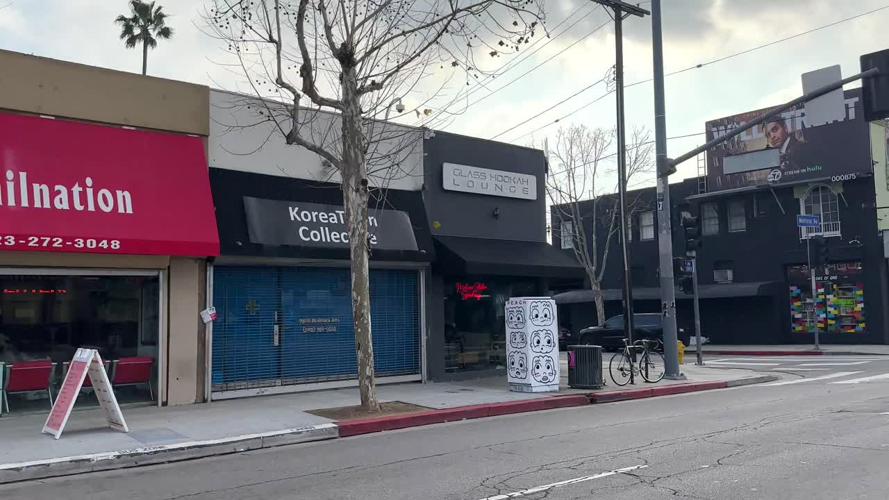 Melrose Ave In Los Angeles, California. Driving Shot Of Shops And People On Famous Street
