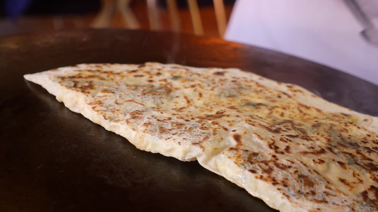 Turkish Pide Cooking on a Hot Plate