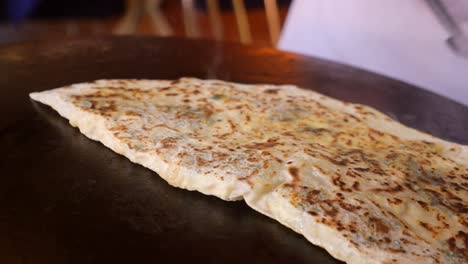 turkish pide cooking on a hot plate