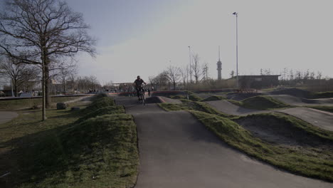 rider on bmx bike going through a pump track, slow-motion shot in goes, the netherlands