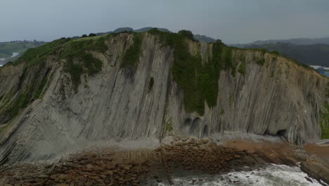 aerial trucking pan around geologic flysch fissures in sea cliffs of zumaia spain