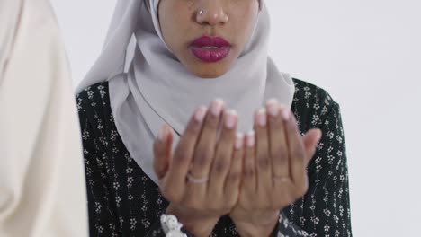 african muslim couple at home in ramadan making traditional fatiha prayer to allah god while wearing a traditional sudan fashion clothes in studio