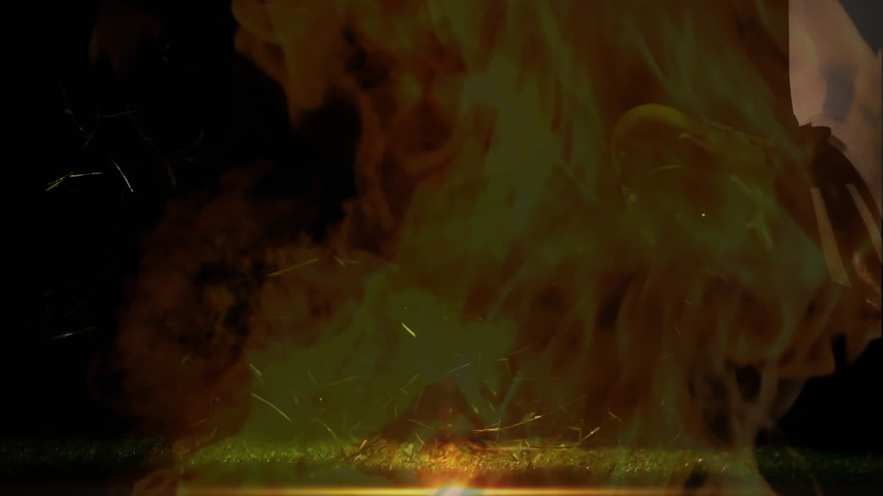 Rugby player kicking ball with fire