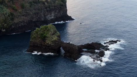 aerial shot of a rock formation that can be seen from the viewpoint located in madeira called miradouro do véu da noiva