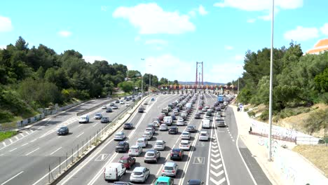 cars passing through the point of toll highway, toll station near the bridge. lisbon, portugal