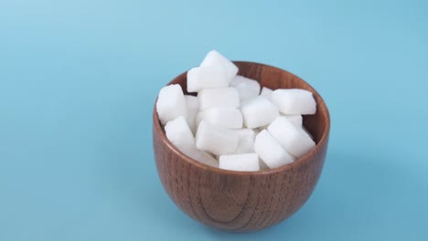 sugar cubes in wooden bowl