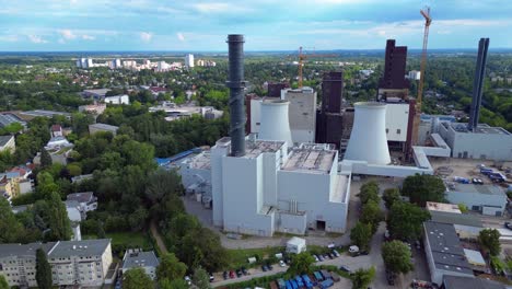 2 crane dismantling a power plant during a demolition process. fabulous aerial view flight speed ramp hyper motion time lapse very close passing flight drone