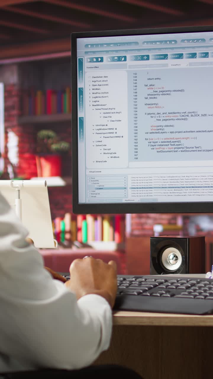 Vertical video Programmer wearing headphones types code into PC, developing software