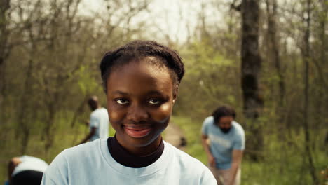 african american girl presenting small sprout with organic soil