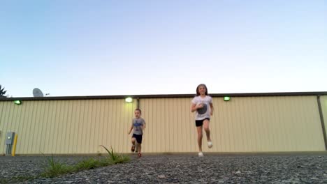 a young boy and girl run away from and toward camera.