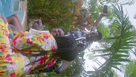 social media influencers recording each other in africa - vertical shot