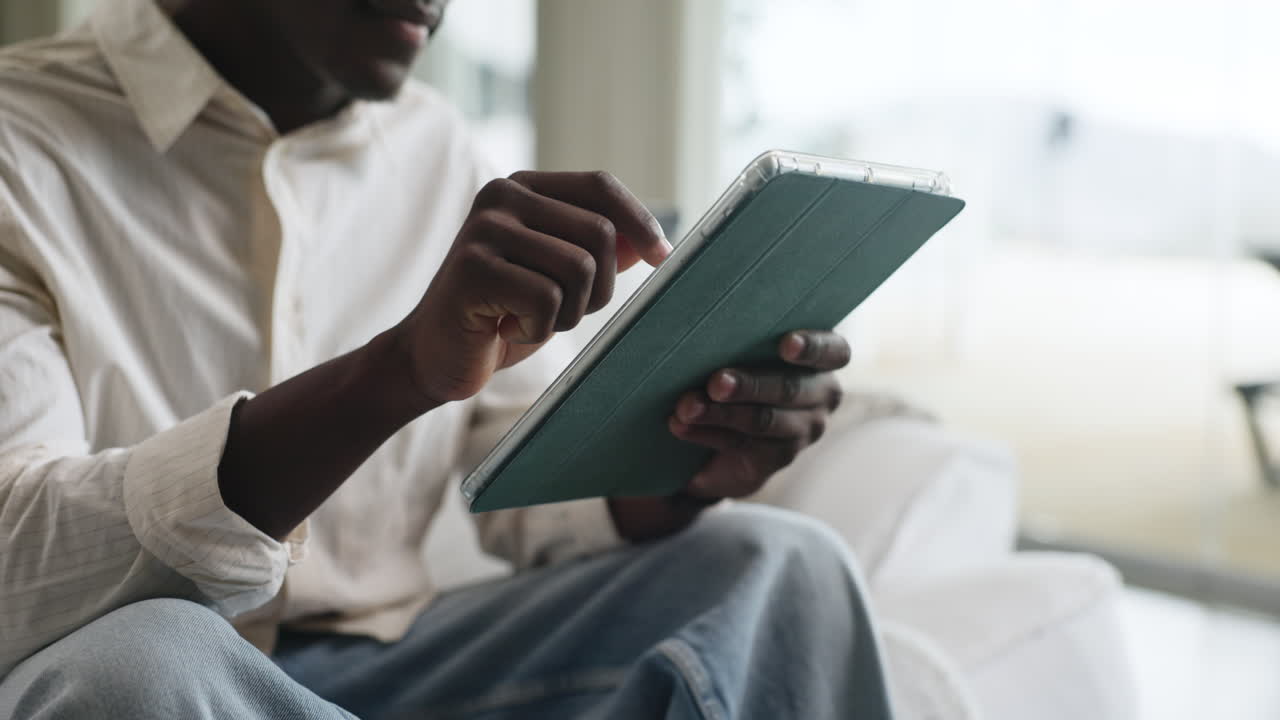 Man using a tablet at home