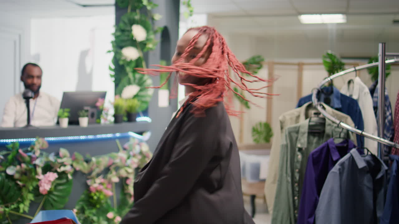 Client dances in fashion boutique