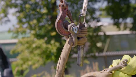 heavy load prepared to lift with crane hook in outdoors site, close up view