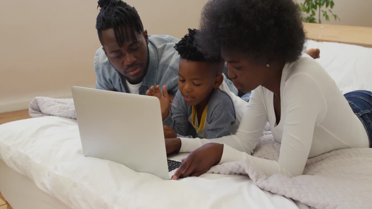 Family using laptop together at home