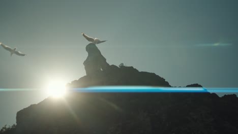 seagulls fly over rock against clear blue sky with sun sunny