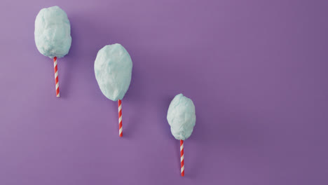 video of marshmallows on sticks lying on purple surface